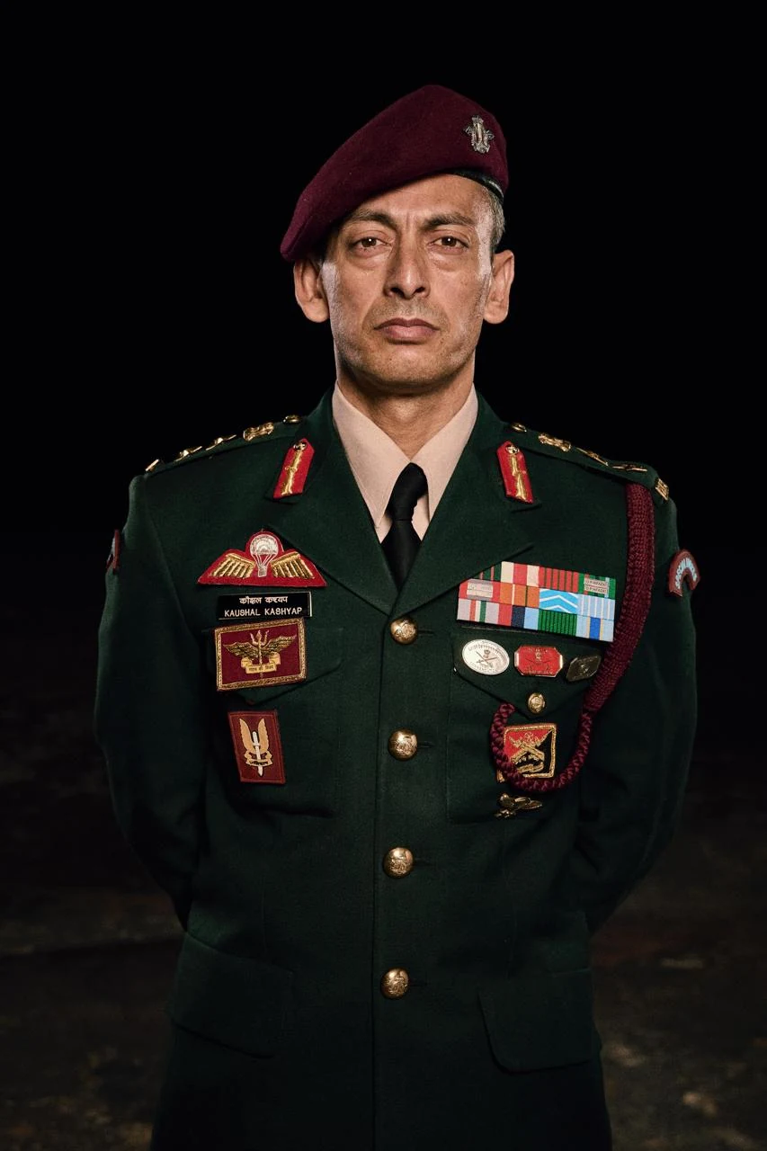 Colonel Kaushal Kashyap in dress uniform and a maroon beret against a dark background